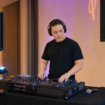 Mobile DJ portable setup with controller, speakers and microphone at an event