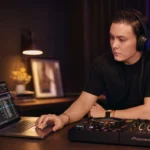DJ planning and building a set on a laptop with a controller