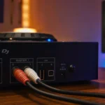 RCA cables plugged into the master output of a DJ controller connecting to speakers