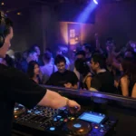 DJ performing to a crowd at an intimate bar venue