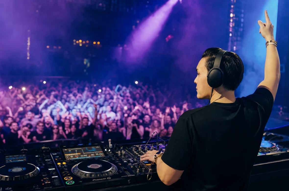 DJ performing to a packed crowd, representing a thriving DJ career
