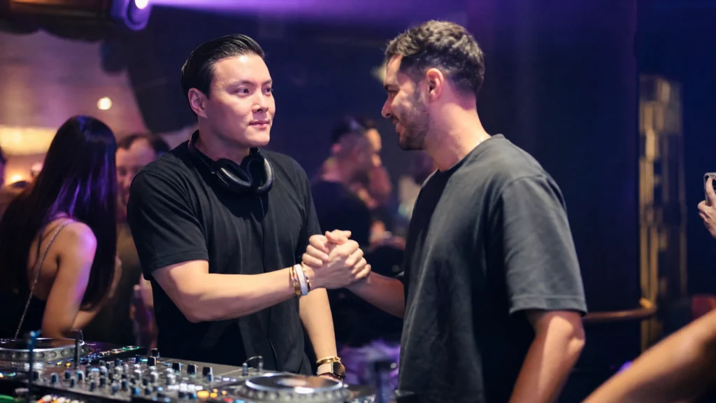 DJ networking with a promoter at a nightclub event
