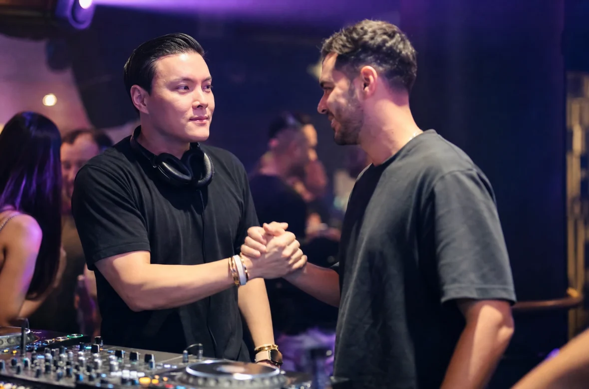 DJ networking with a promoter at a nightclub event