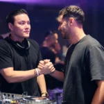 DJ networking with a promoter at a nightclub event