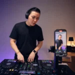 DJ filming a performance clip for social media in a home studio