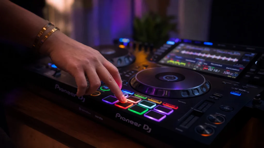DJ pressing colored hot cue performance pads on a controller