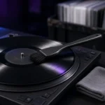 Carbon-fibre brush cleaning a vinyl record on a DJ turntable beside cleaning fluid and a microfibre cloth