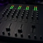 Four-channel club DJ mixer with glowing level meters and EQ knobs in a dark DJ booth