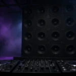 Stack of large subwoofers and a DJ booth in a dark club, evoking the heavy bass of dubstep