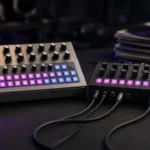 Analogue drum machine and bass synthesizer with glowing step buttons in a dark studio